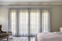 Elegant Melody vertical sheers in soft white, offering light filtering and privacy for large windows.