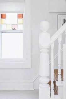 White cellular shades bring light in to an entryway