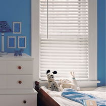 Real wood blinds in a kids' room, providing a natural, stylish look with effective light control and durability.